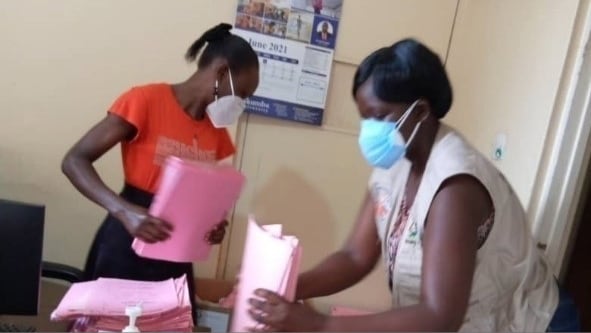 Advanced FETP fellow Sarah Elayeete searches for COVID-19 patients records at a Kampala Hospital