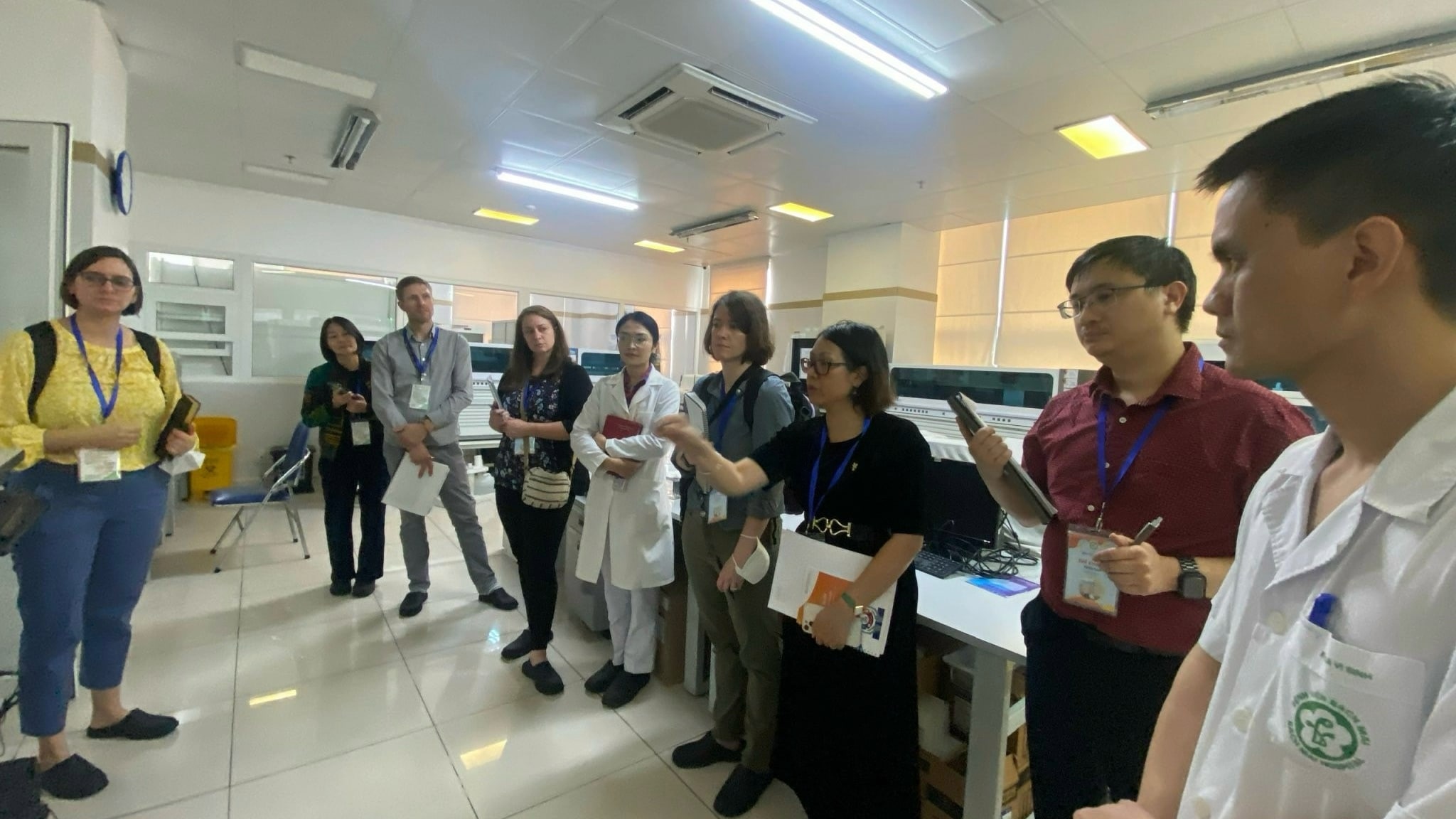 A group of men and woman standing in a lab