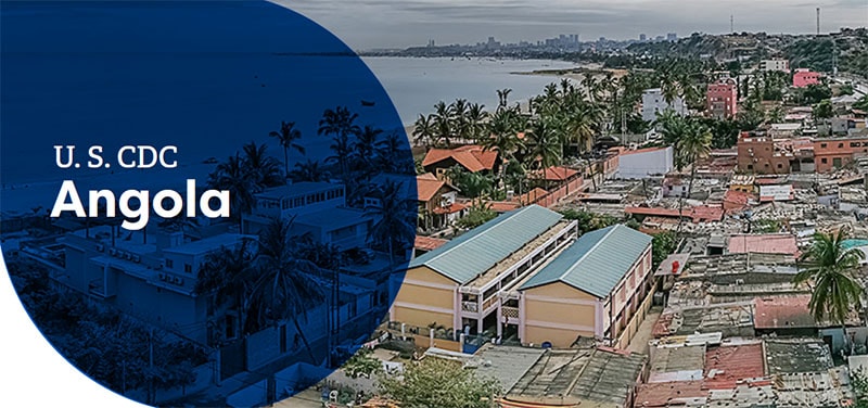 Aerial view of coastal Angola featuring urban areas with palm trees and distant city skyline.