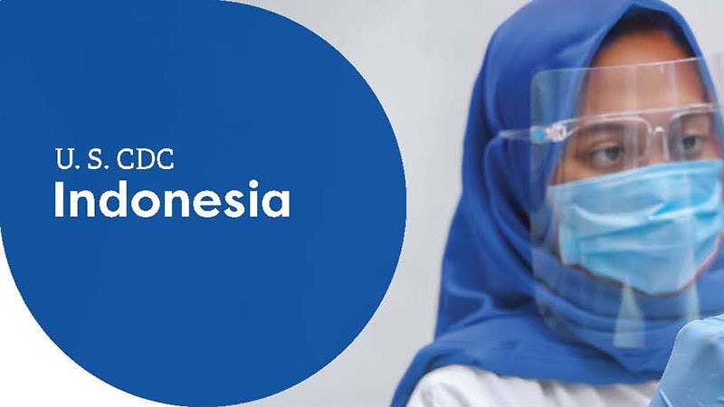 Healthcare worker in protective gear and headscarf, labeled "U.S. CDC Indonesia."