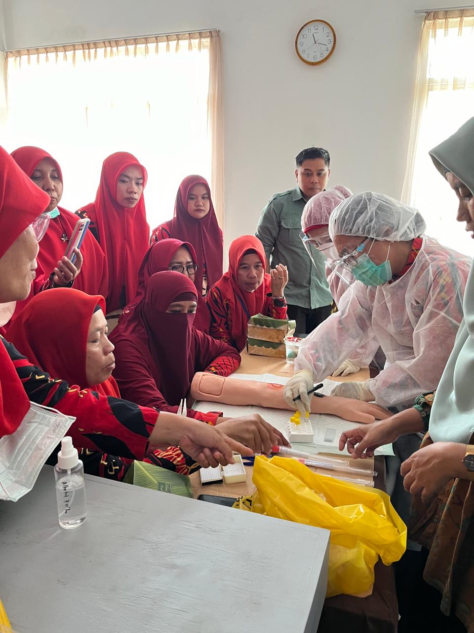 Group of healthcare workers train on anthrax specimen collection.