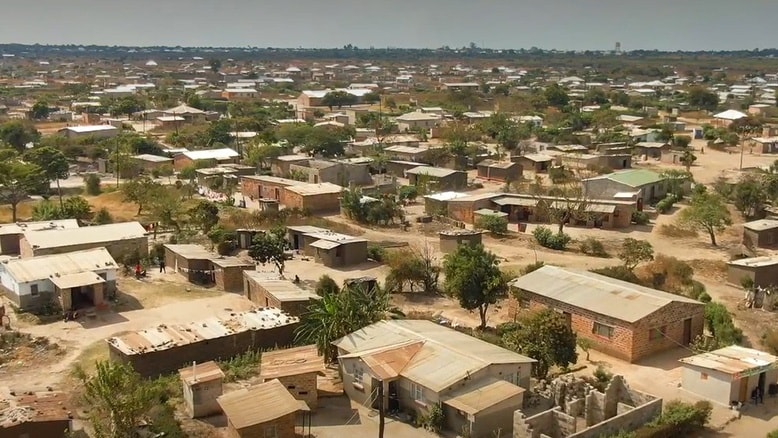 This image shows an aerial view, with houses, trees, and roads, in Lusaka, Zambia.
