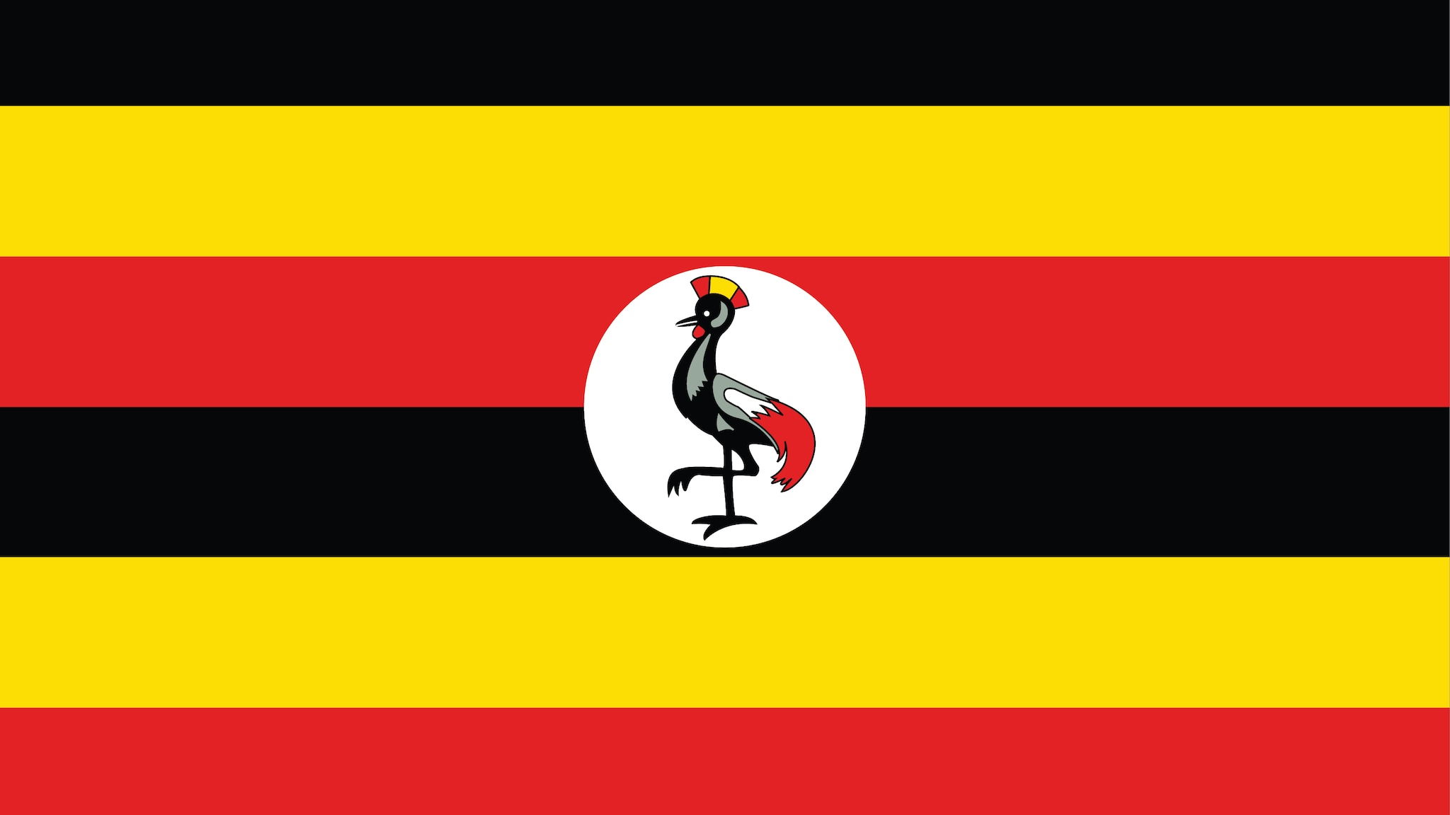 The flag of Uganda consists of six horizontal stripes of black, yellow, and red colors, alternating with each other. The top stripe is black, followed by yellow, then red, and so on. In the center of the flag, there's a white circle, inside which there is a grey crowned crane, the national bird of Uganda, standing on one leg.