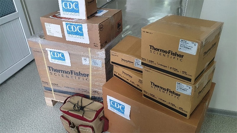Photo of two stacks of cardboard boxes with "CDC" on them.