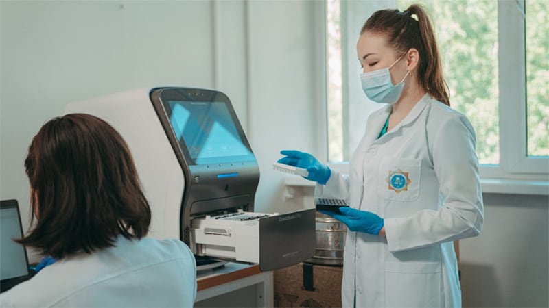 Photo of a laboratorian using lab equipment.