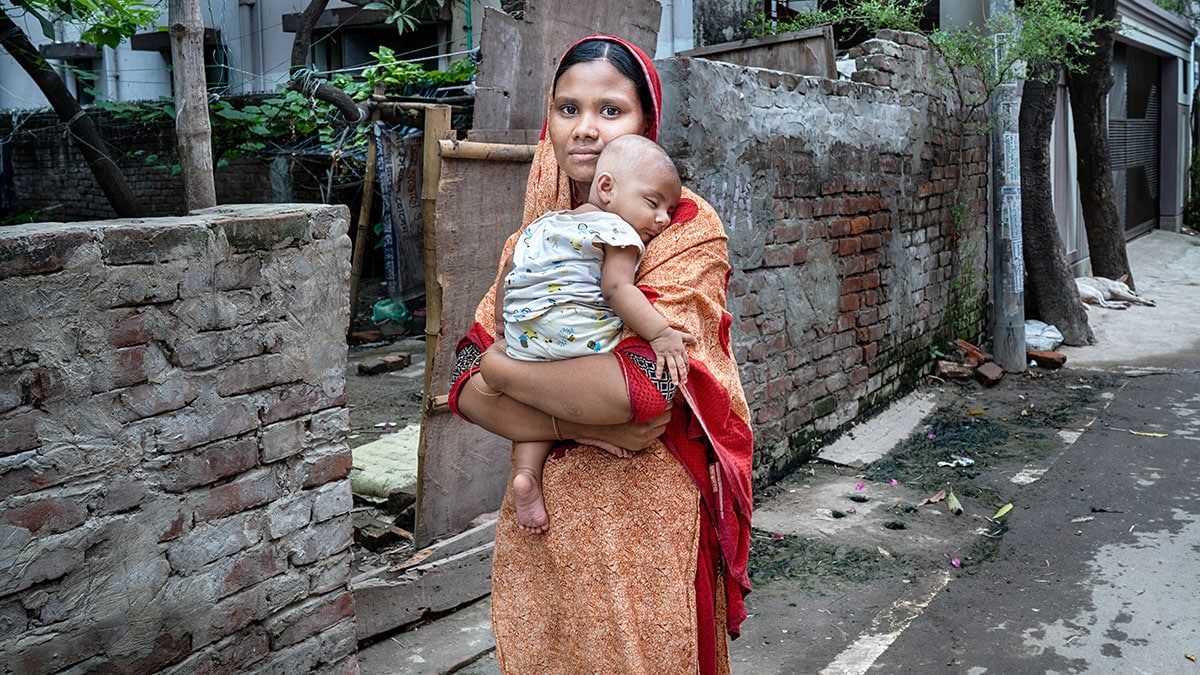 A mother carrying her four-month-old son.