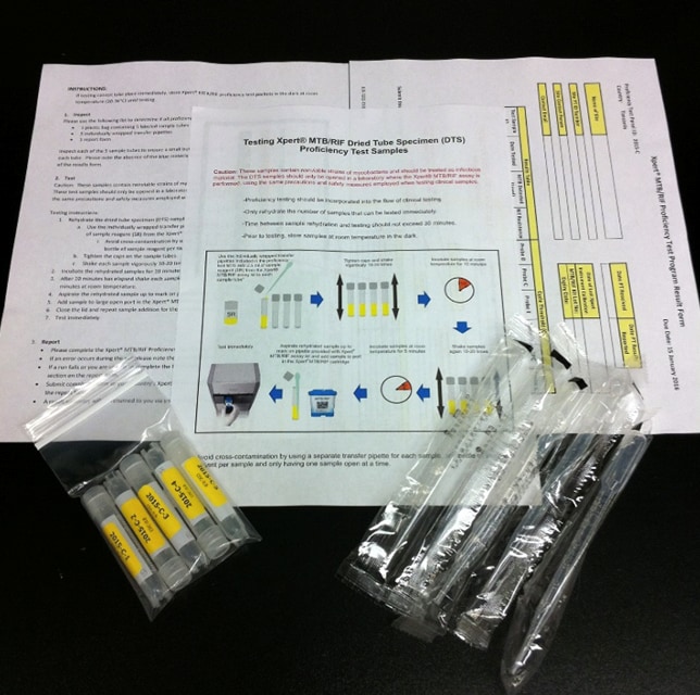 A pamphlet, vials, and materials that are included in an Xpert TB Proficiency Testing program sample kit.