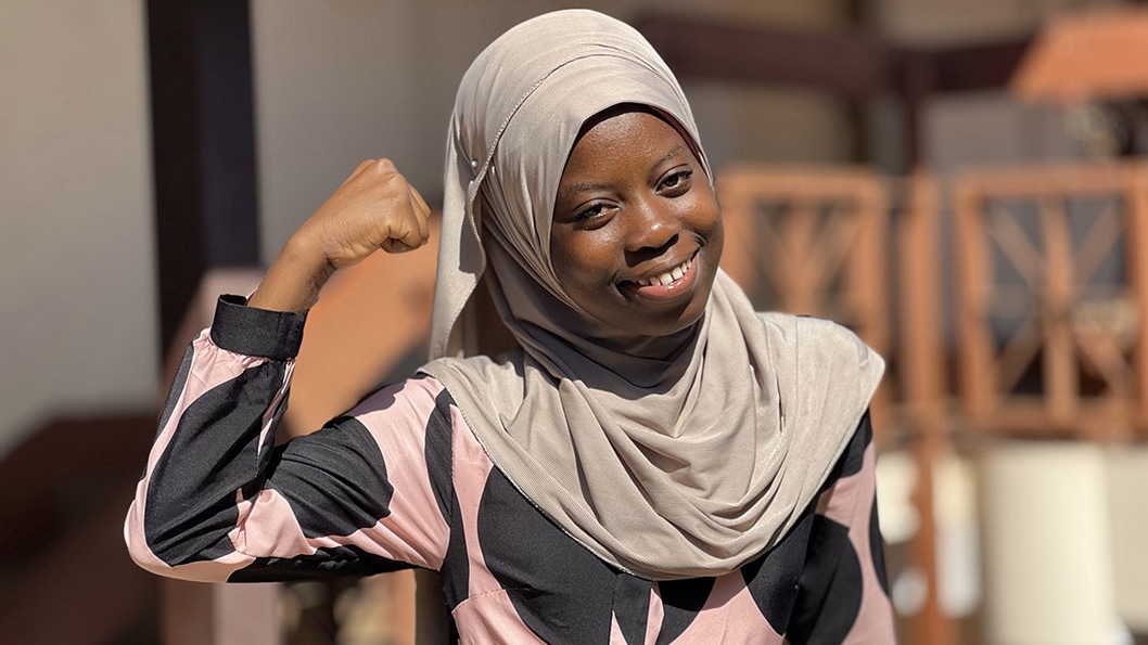 Portrait of a smiling young woman wearing a hijab.