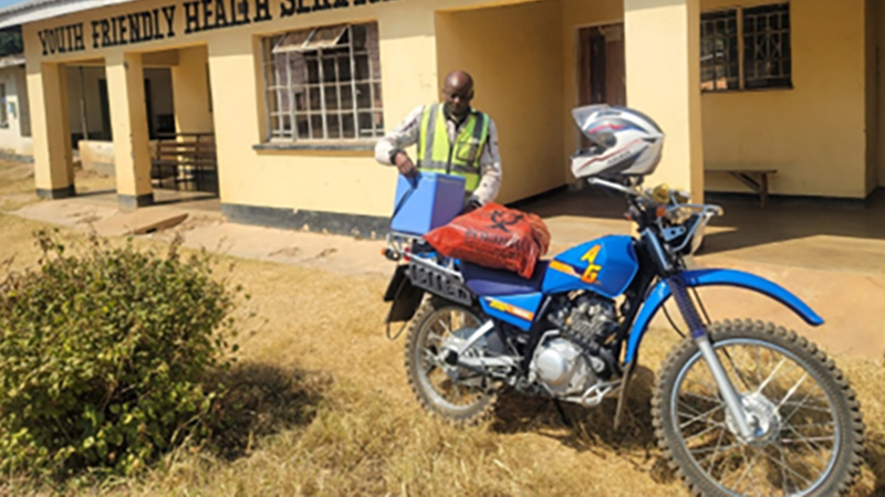A rider prepares lab samples for transport in Malawi.