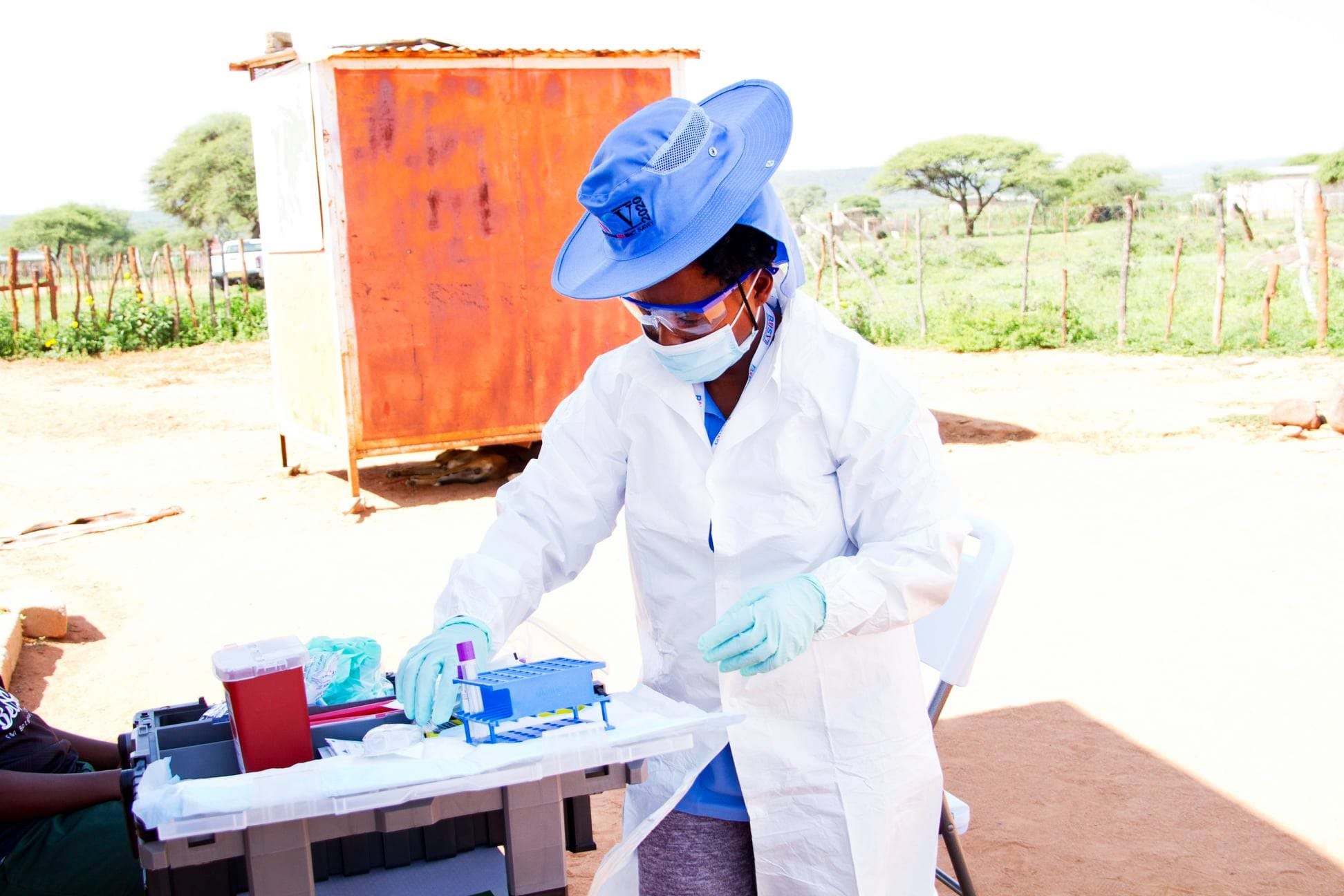 Photo of a healthcare worker providing field testing for HIV.