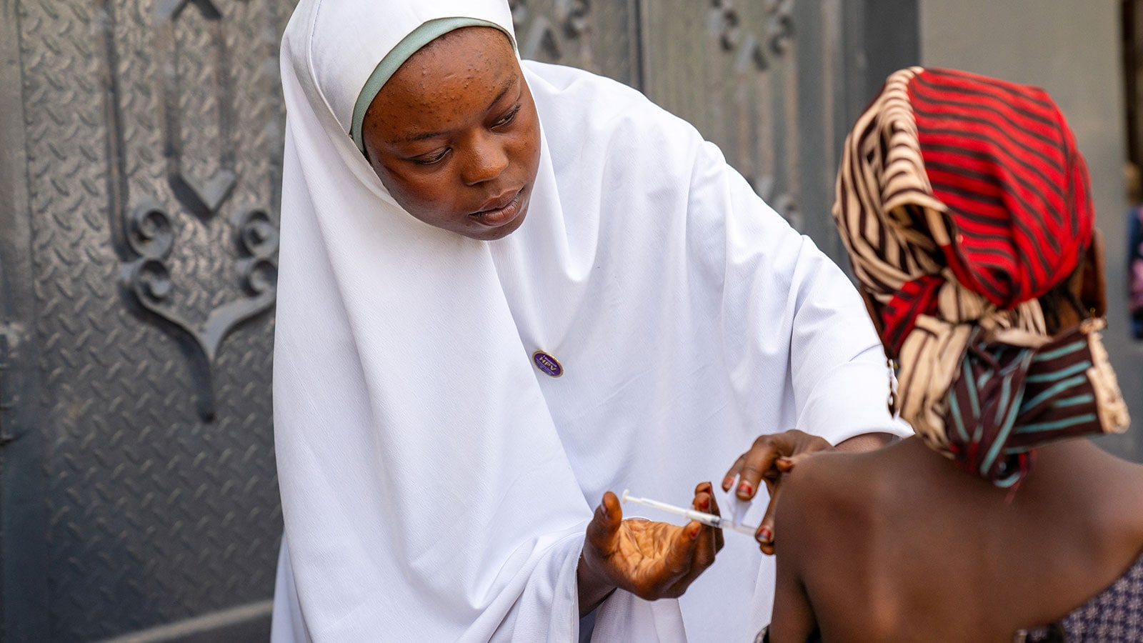 A nurse administers a human papillomavirus (HPV) vaccine at a mobile clinic in Katsina, Nigeria