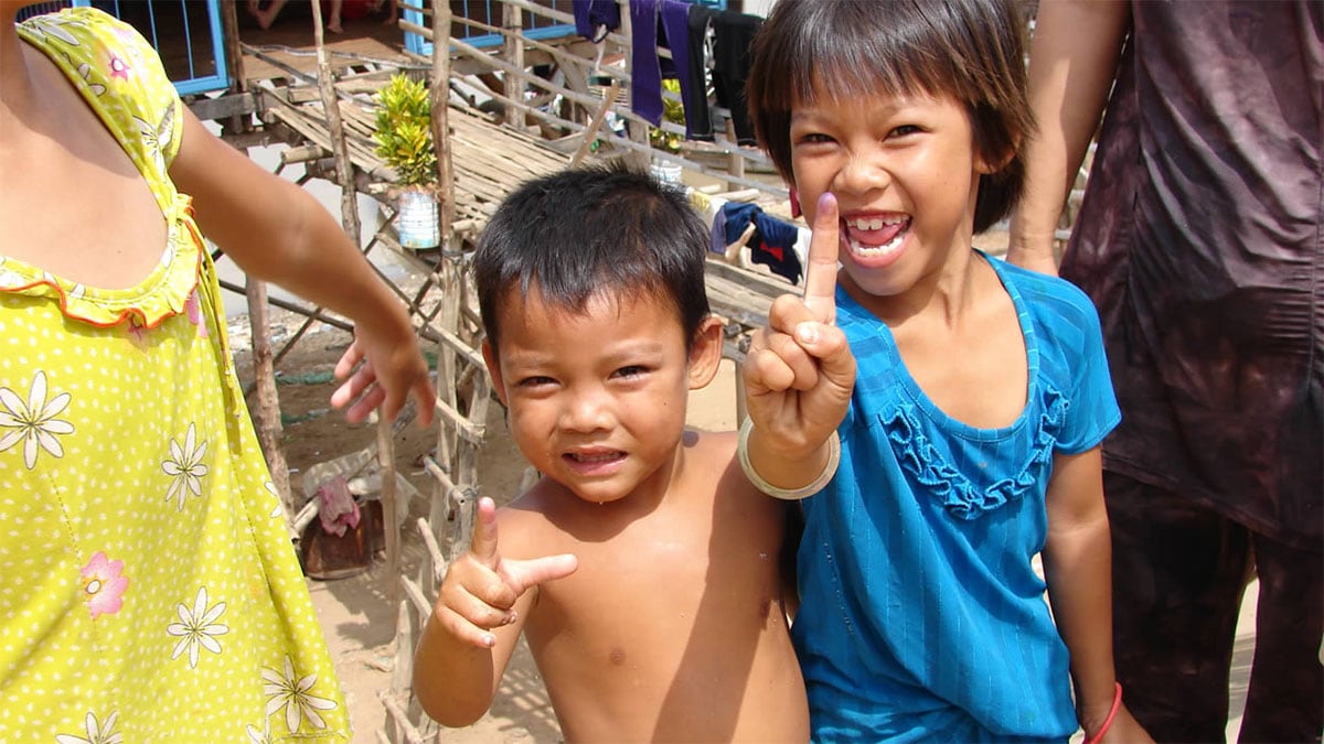 In Cambodia, children proudly lift their marked fingers showing proof of their vaccination.