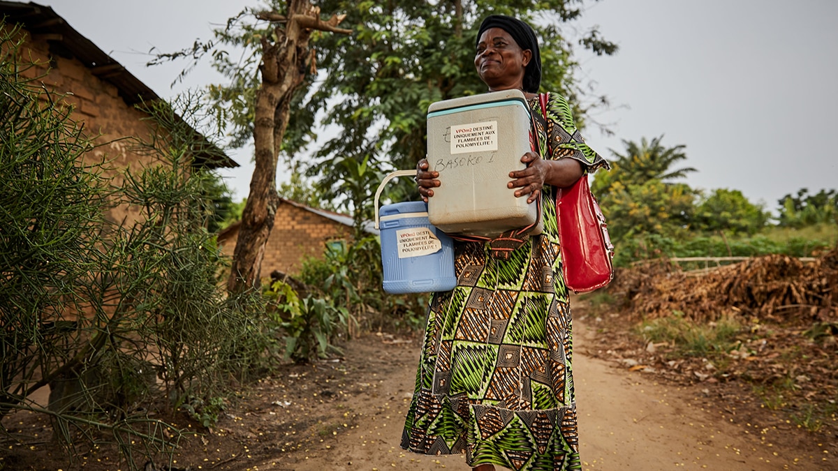 Woman delivering vaccines in coolers