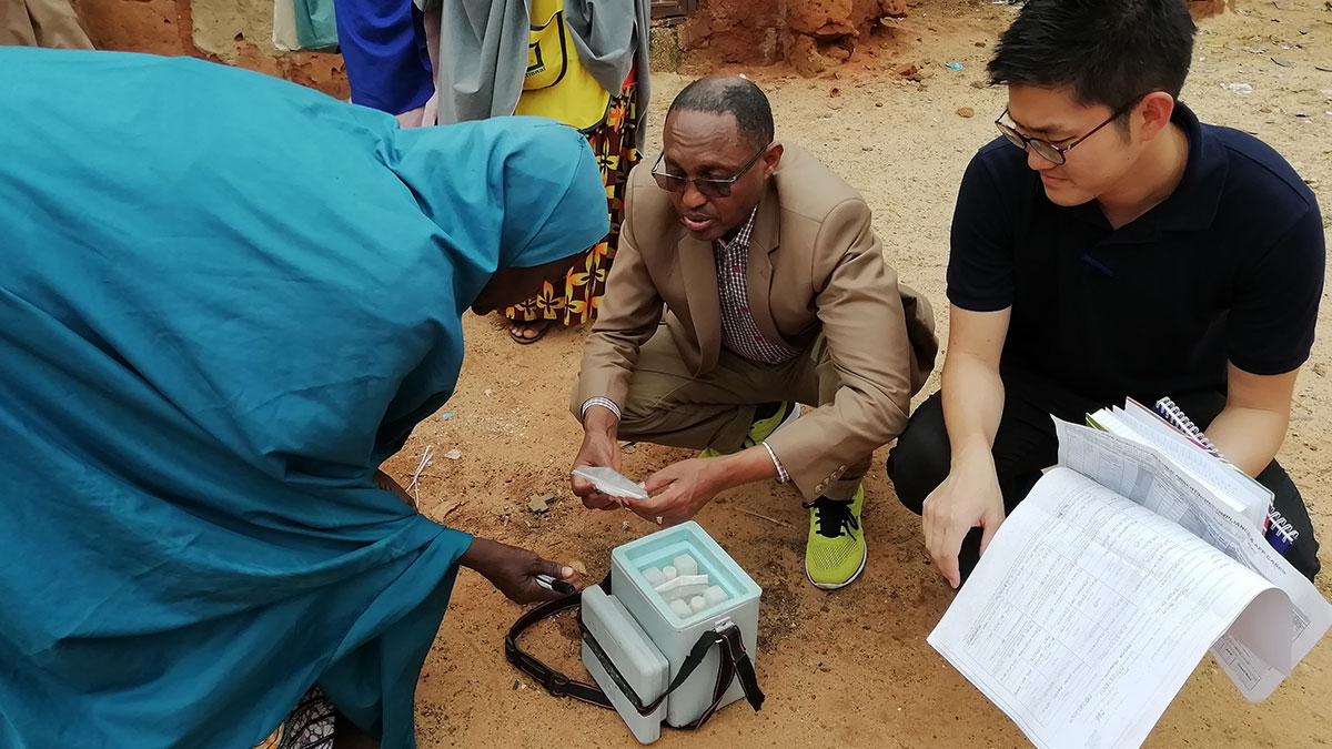 Frontline vaccine worker talks to mentors to review the contents of the vaccine box with a frontline vaccinator during a polio campaign in Sokoto State, Nigeria.