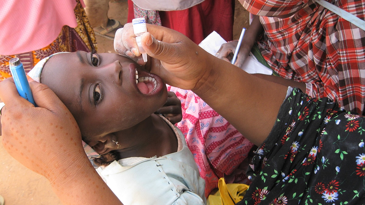 Girl receiving an oral vaccine