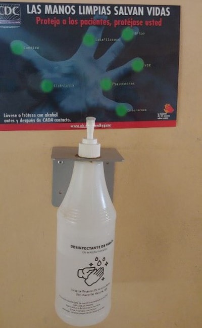 Hand hygiene educational materials with locally produced alcohol-based hand rub at a hospital in Moca, Dominican Republic.