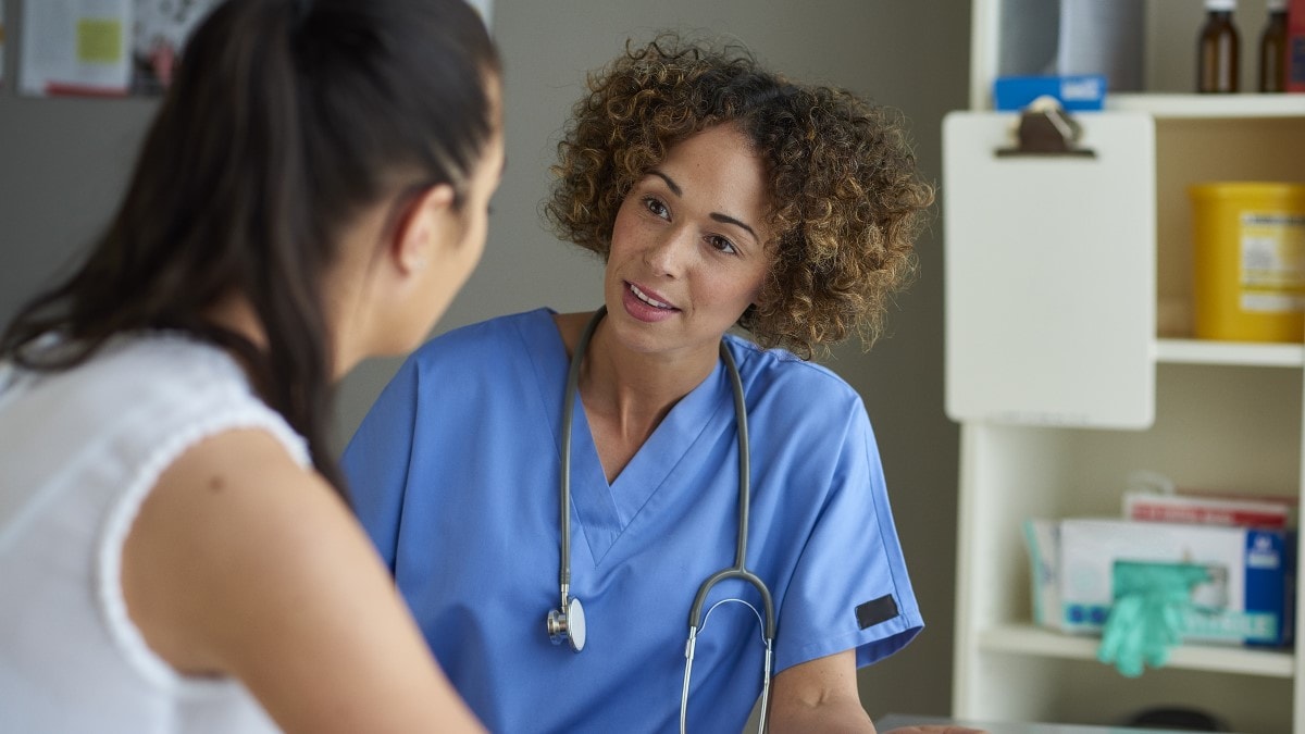 Healthcare provider talking to a patient in a doctor's office