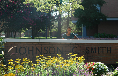 Kameron Sheats standing by the wall sign at Johnson C. Smith University
