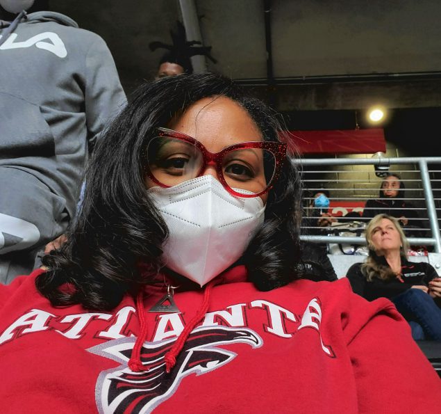 Melinda Jordan wearing a N95 mask at an Atlanta Falcons Game.