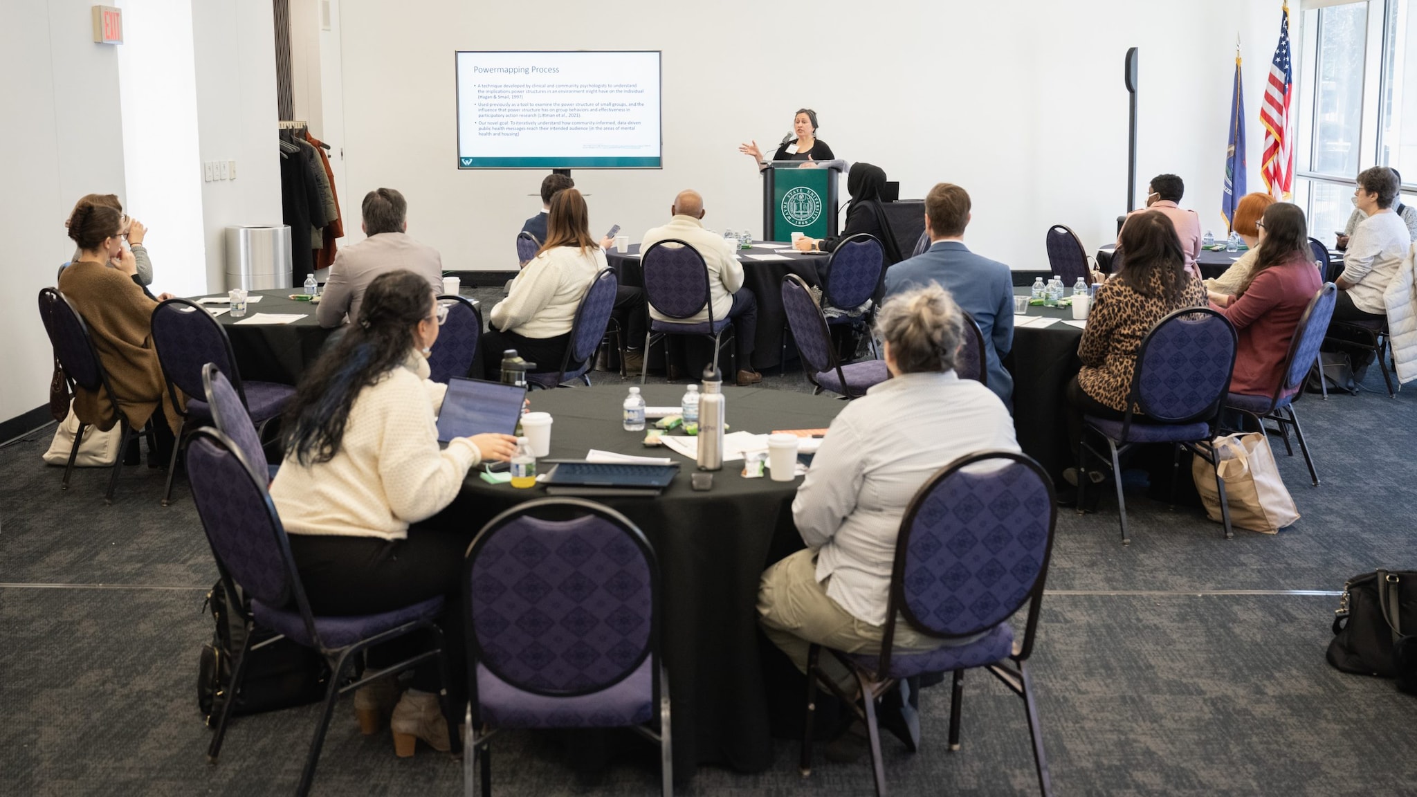 Image of Professor of Public Health at Wayne State University speaking at a community meeting.