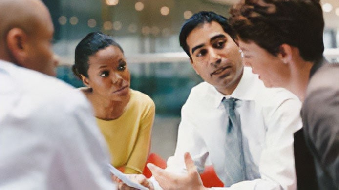 Group of four people in a meeting.