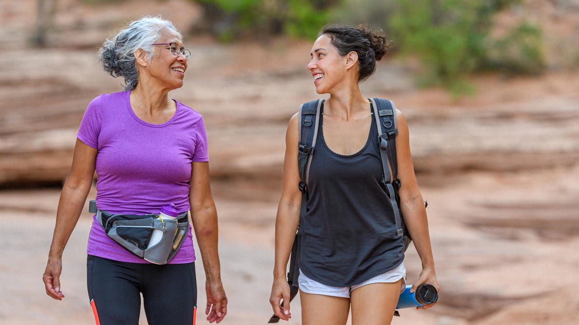 Two women walking in a desert