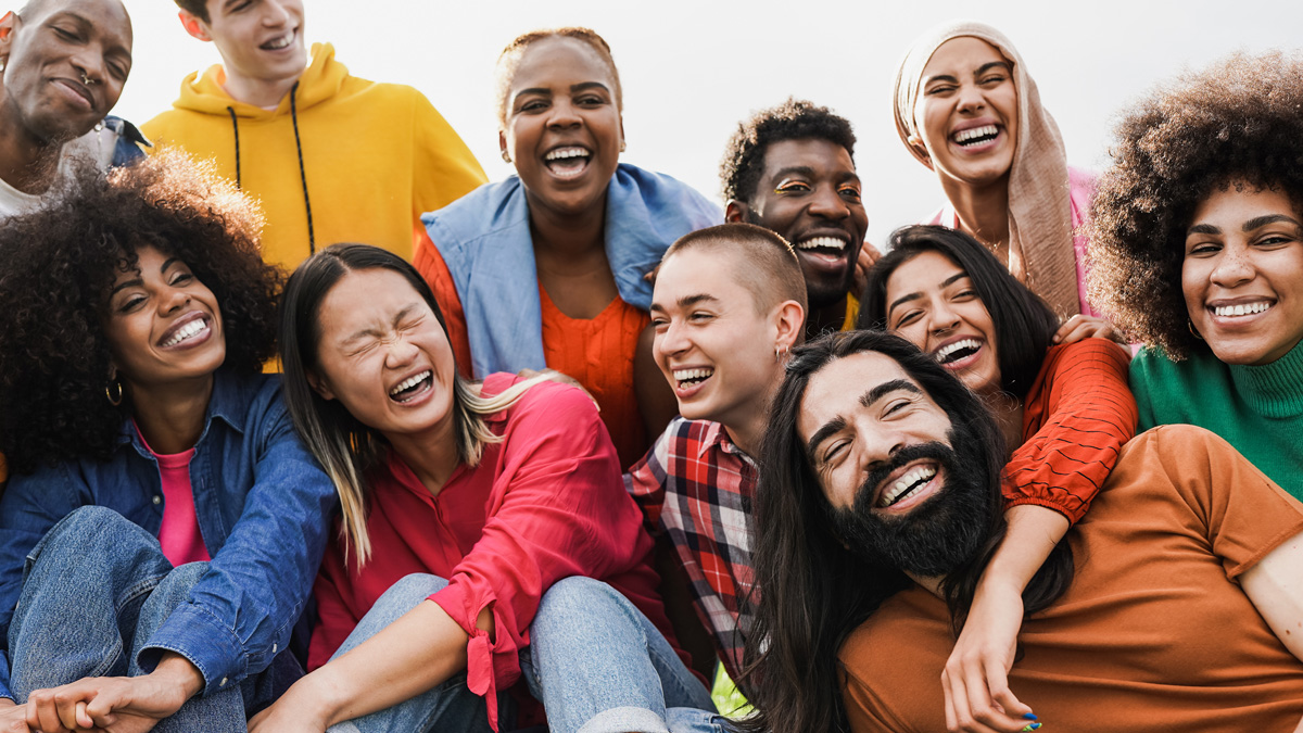 A group of LGBTQ youth smiling.