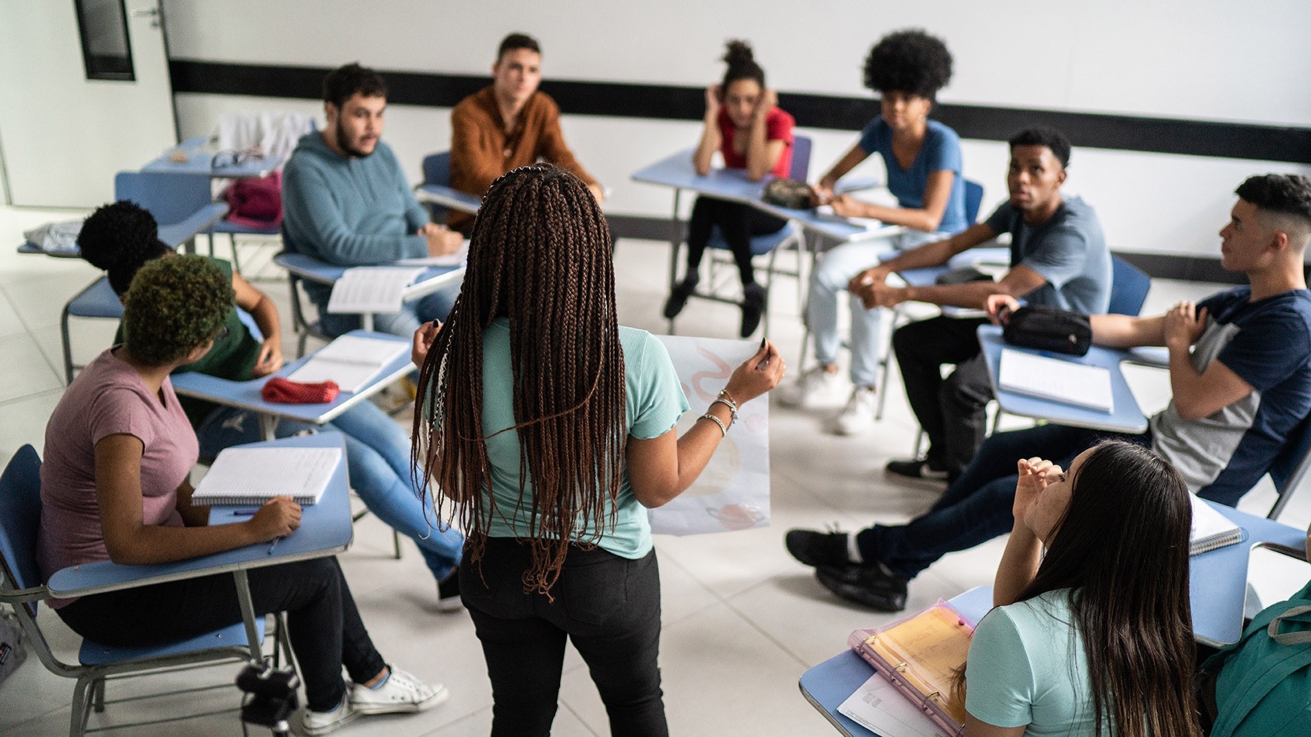 A study group with teacher and students address the mental health education.