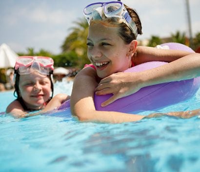 Image of two girls swimming in pool