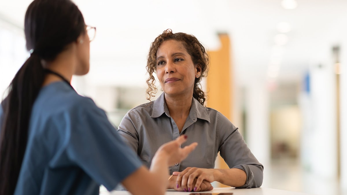 Female doctor talking with her senior patient