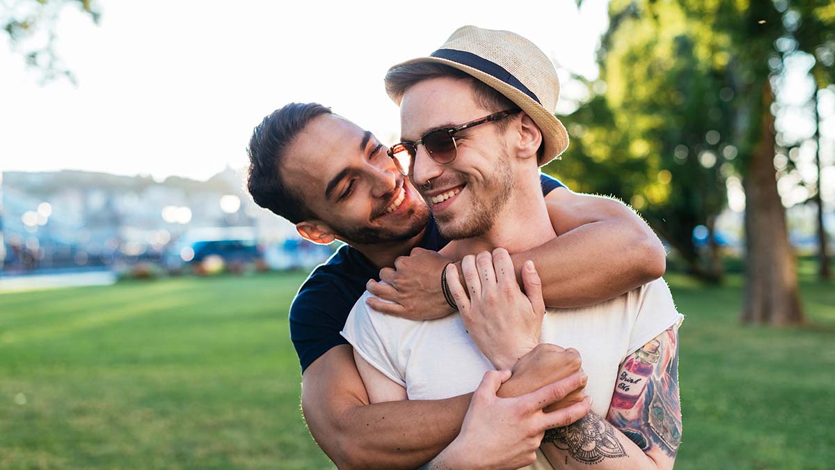 Two men hugging that are vaccinated against hepatitis A and hepatitis B