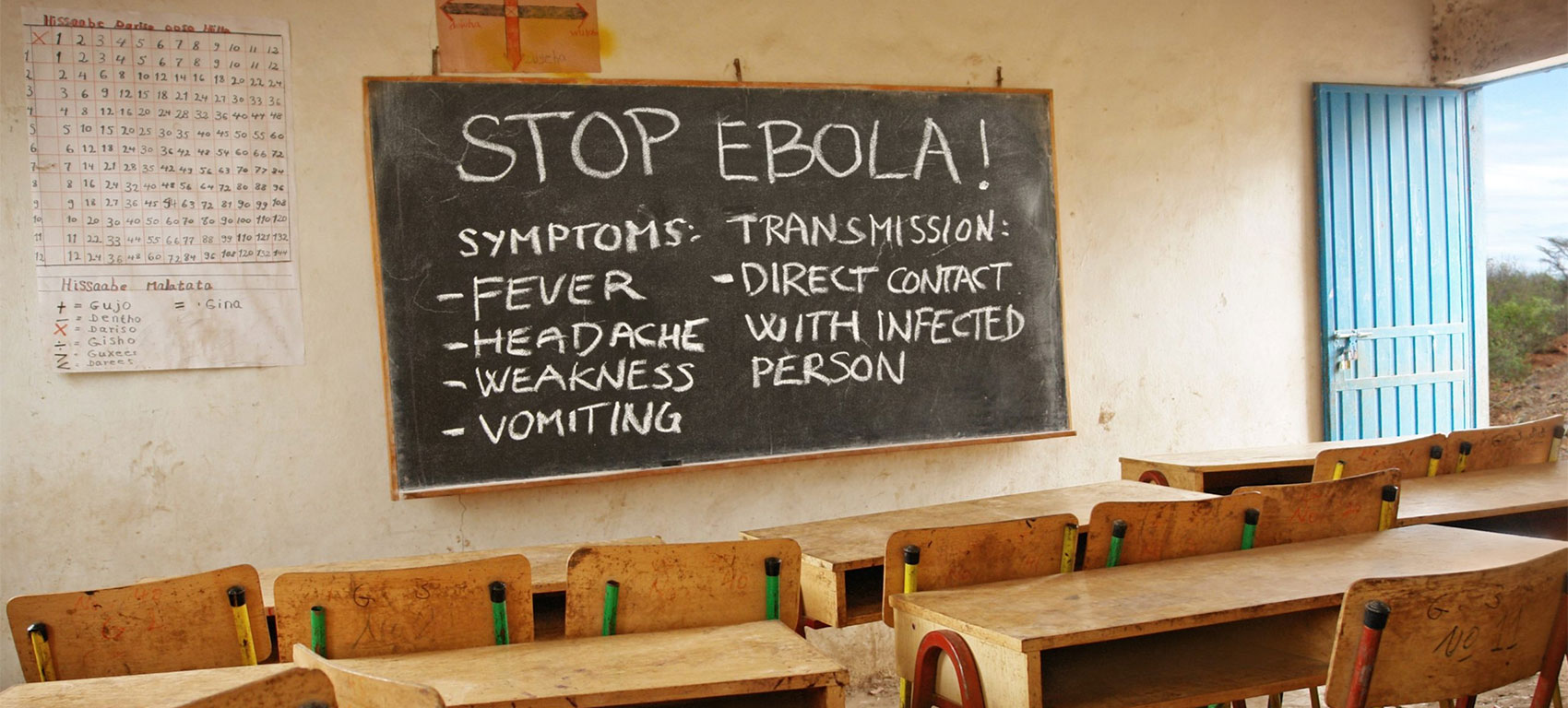 Classroom with Ebola prevention guidance written on a chalkboard.