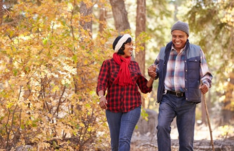 Image of a smiling couple hiking in autumn