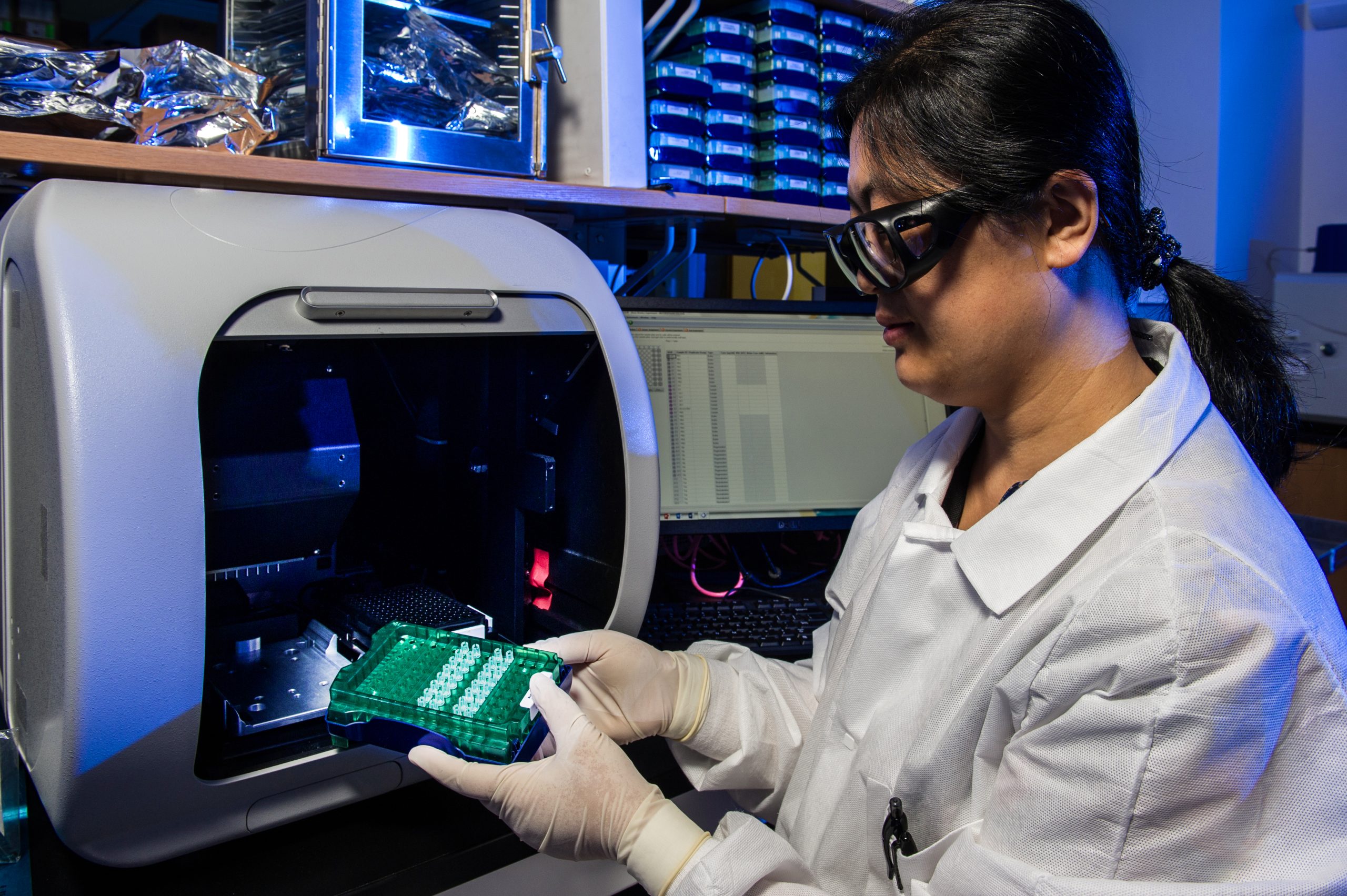 Laboratory technician scanning data test tubes