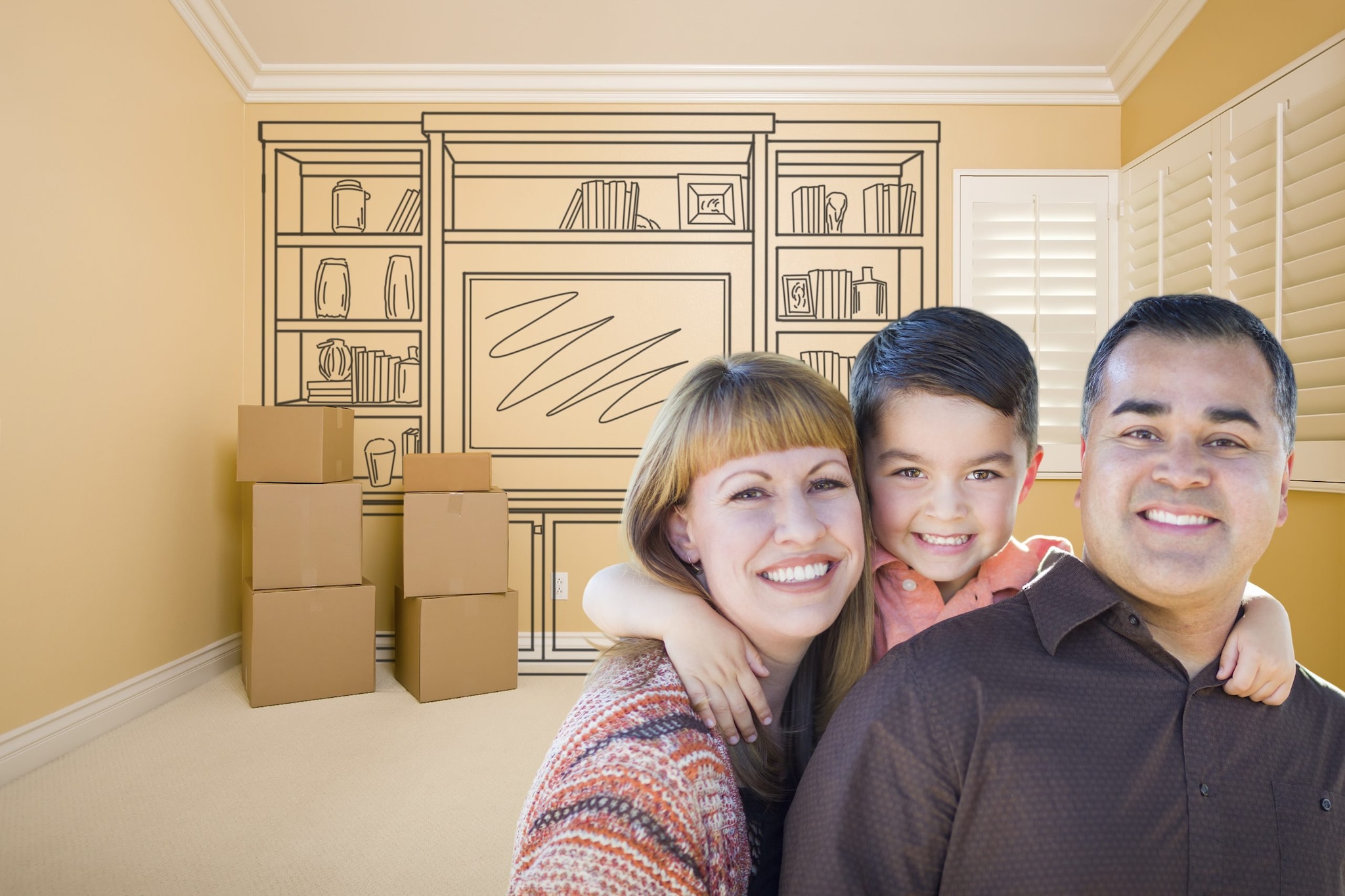 A woman, young boy and a man with moving boxes and a drawing of furniture in the background.
