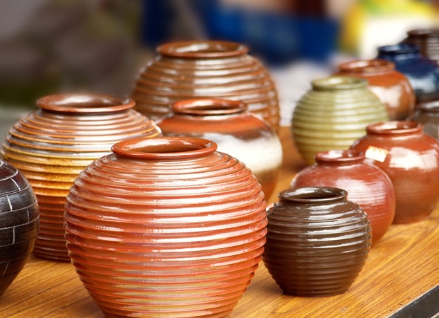 Several ceramic pots sitting on a table.