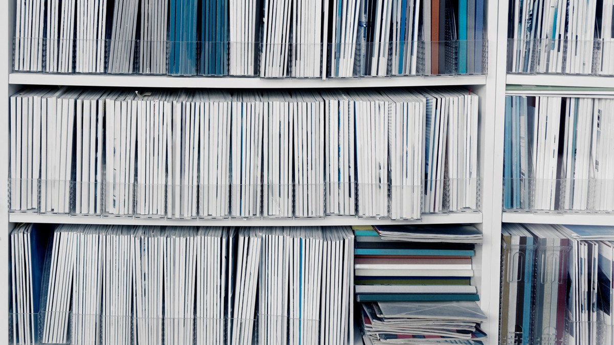 Shelves of medical references are filled with journals for reference.