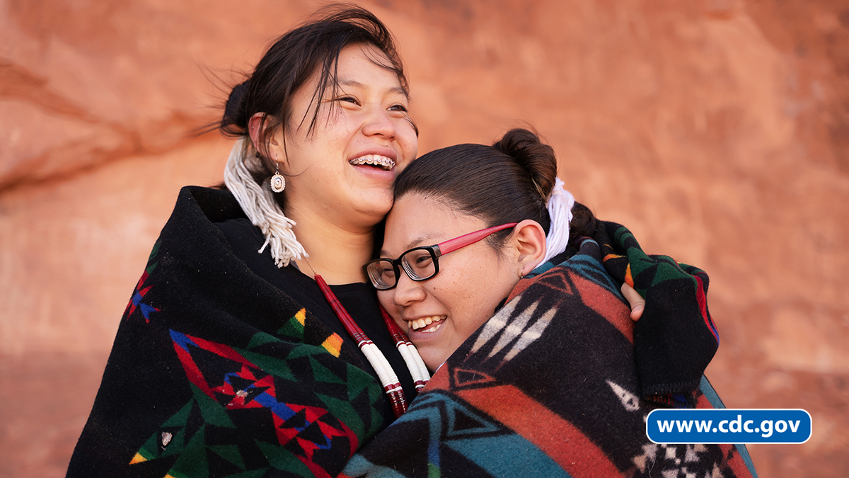Native American women hugging