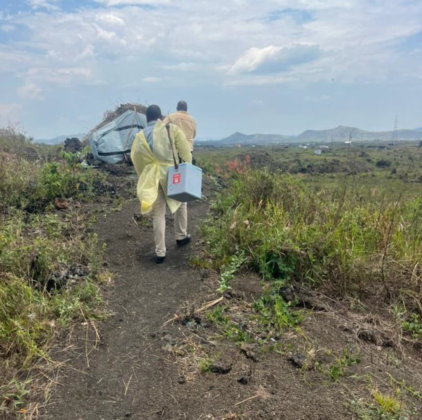 Two people head to a rural area to give mpox vaccinations