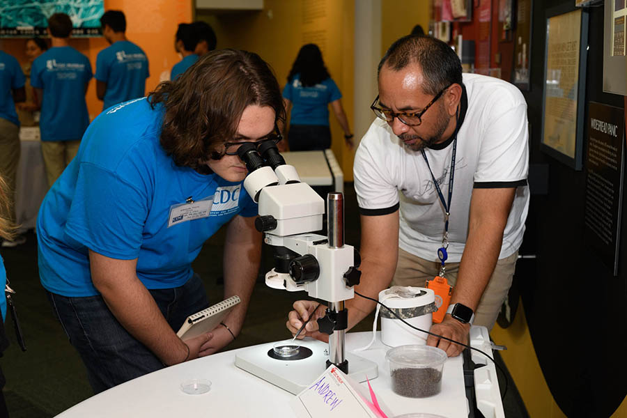 student-microscope Student using laboratory equipment.
