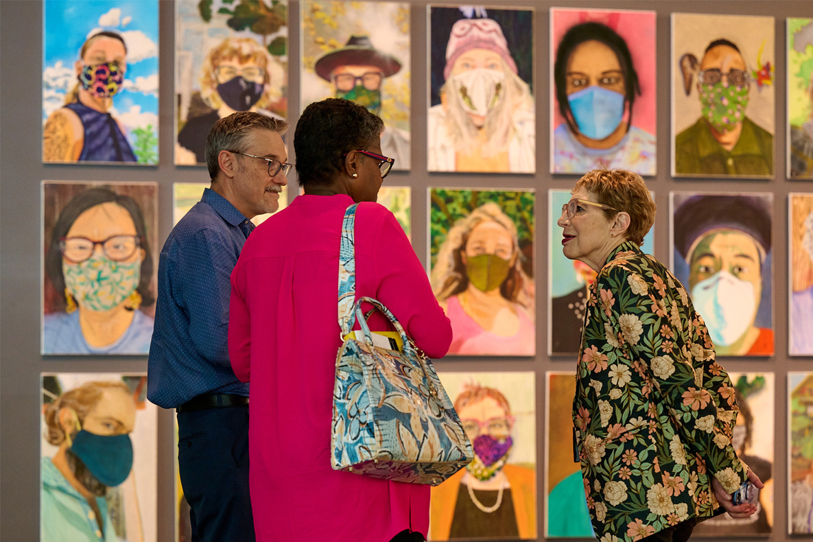 A man and two women talking in from a a collage for people wearing masks