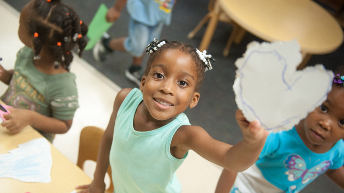 Girl holding paper heart 1200x675 Girl holding paper heart happy