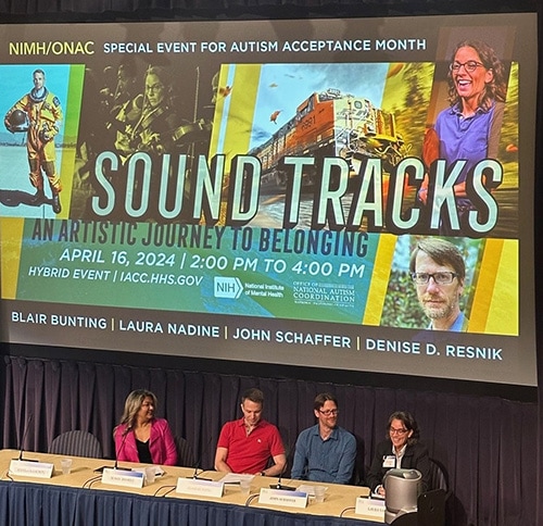A slide with text "Sound Tracks: An Artistic Journey to Belonging" and pictures of the presenters is being shown behind the panelists at the event.