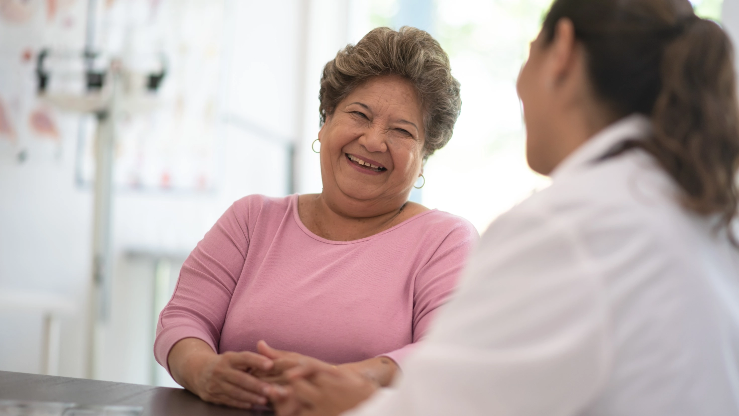 Middle-aged female patient talking with doctor