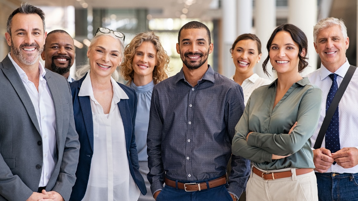 Portrait of successful group of businesspeople at modern office looking at camera.