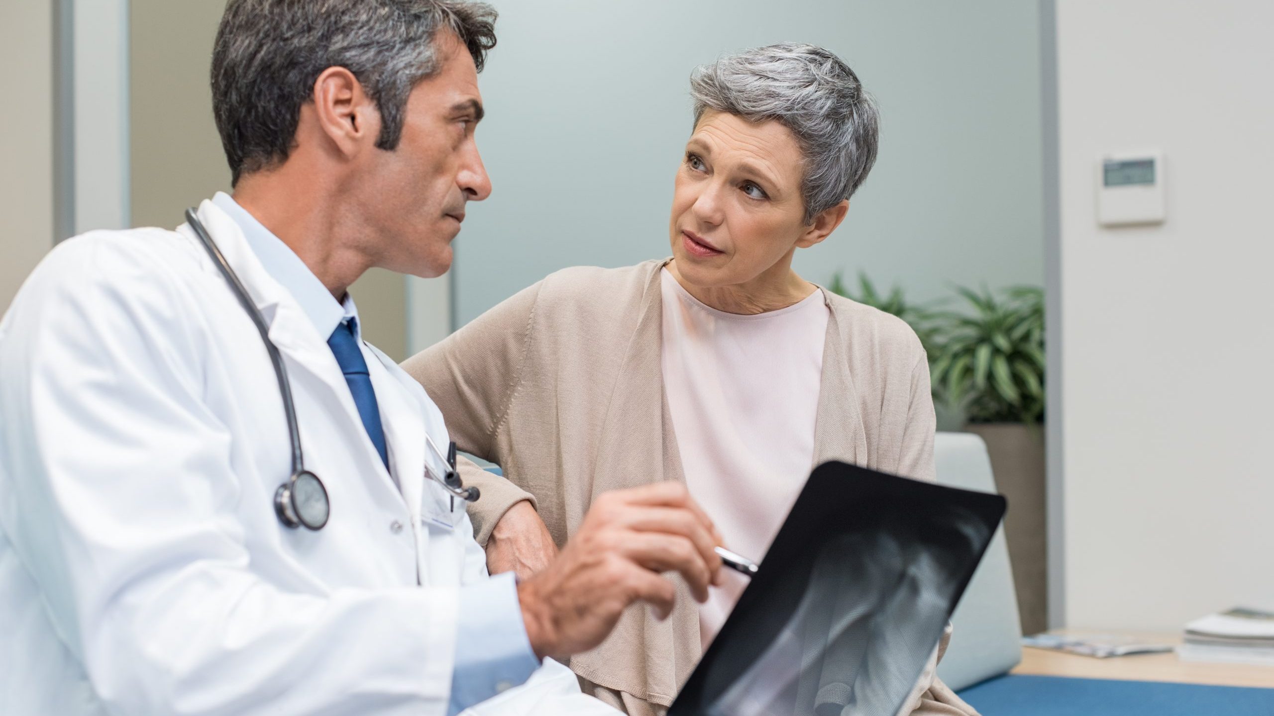 Doctor talking to senior patient about x-ray