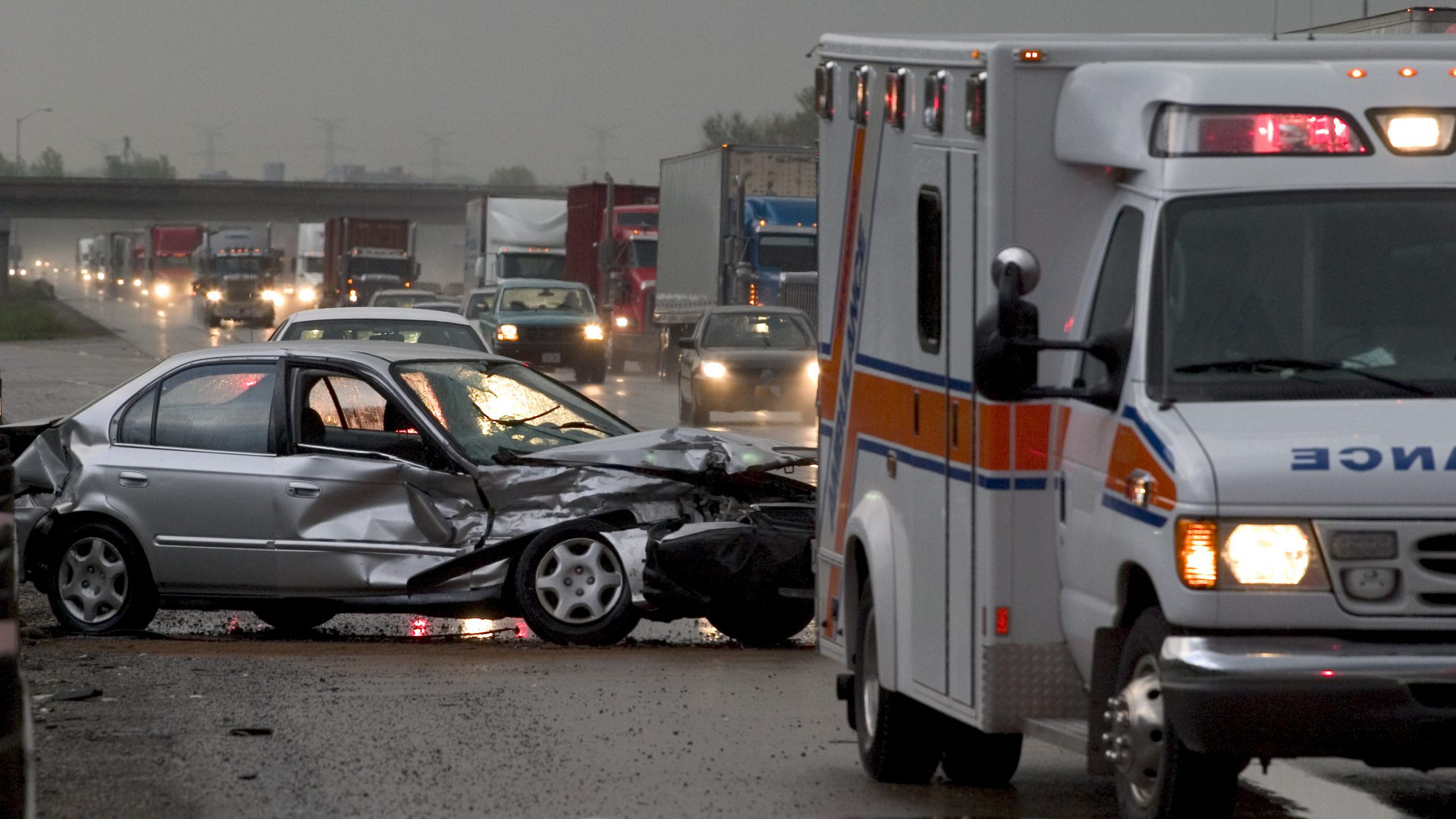 Traffic stopped behind an ambulance and a crashed car