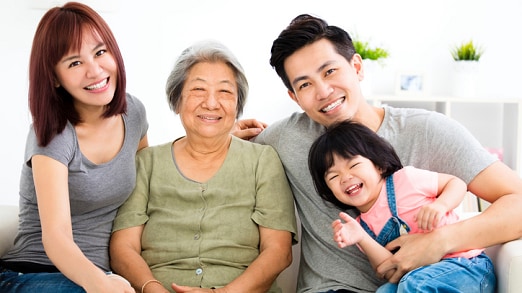 Picture of smiling Asian family--child, mom, dad, and grandmother