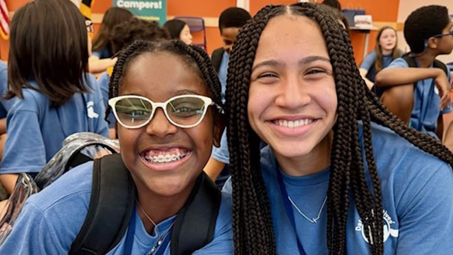 Two girls smiling.