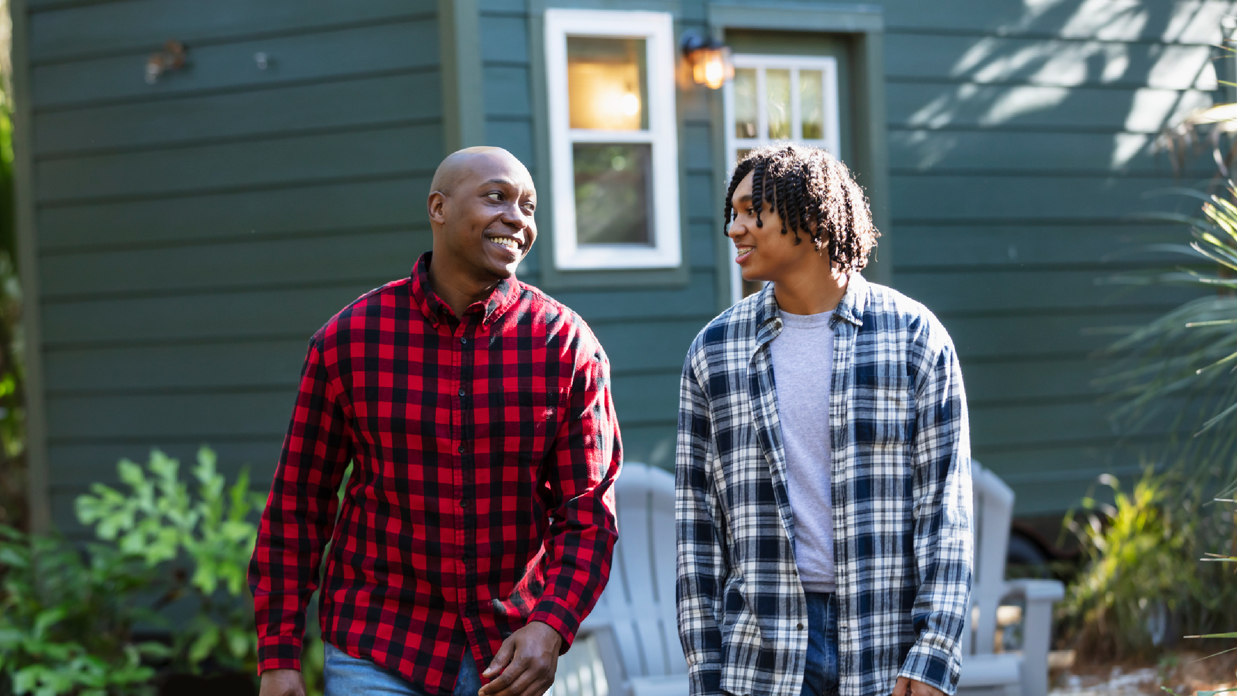 Parent and teen walking and talking outside